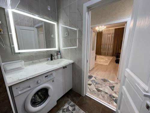 W łazience znajduje się pralka i umywalka. w obiekcie Жк Керуен Сарай w mieście Türkistan