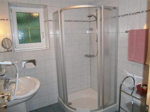 a bathroom with a shower and a sink at Alpenview Lechtal in Holzgau