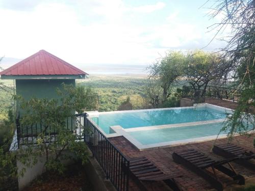 a swimming pool with a view from a house at Lake Manyara View Luxury Tented Camp in Mto wa Mbu