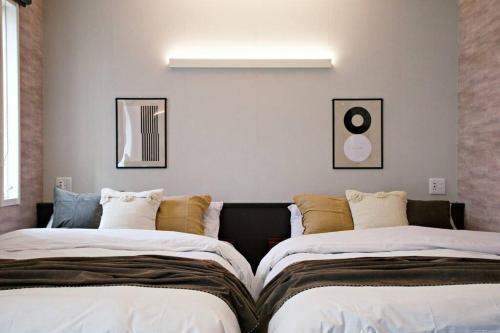 two beds sitting next to each other in a room at ザ・マスターズステイ世田谷経堂 201 in Tokyo