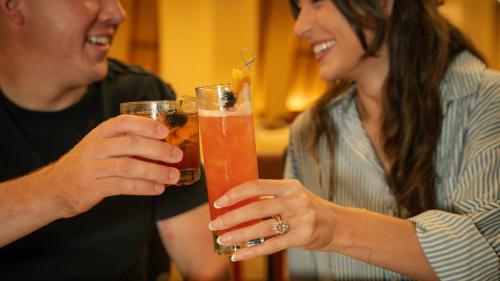 a man and woman holding drinks in their hands at Crowne Plaza Houston Med Ctr-Galleria Area by IHG in Houston