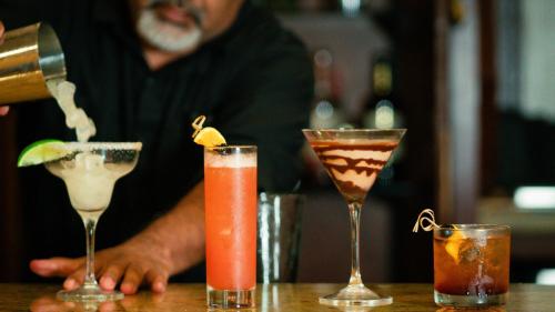 a group of three cocktails sitting on a table at Crowne Plaza Houston Med Ctr-Galleria Area by IHG in Houston