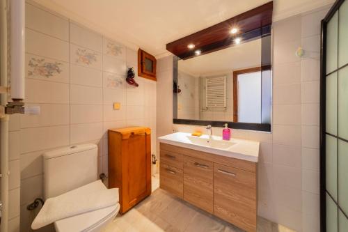 a bathroom with a toilet and a sink and a mirror at Flat with Balcony 3 min to Fosforlu Beach in Antalya