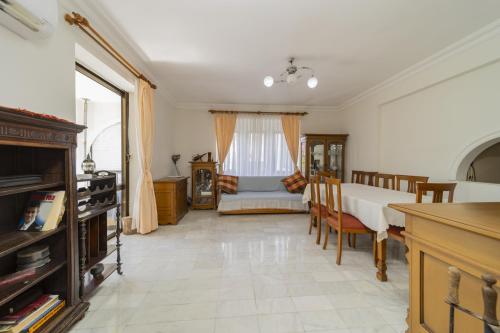 a kitchen and dining room with a table and chairs at Flat with Balcony 3 min to Fosforlu Beach in Antalya