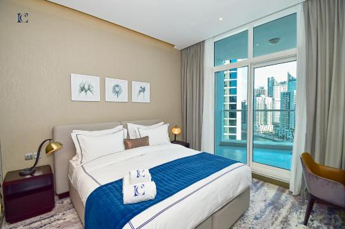 a bedroom with a large bed and a large window at Canal View Studio Apartments - DAMAC Prive Business Bay in Dubai