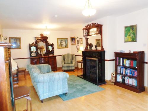 a living room with a couch and a fireplace at Redwood in Killarney