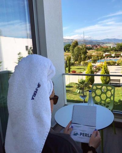 a person with a towel on their head sitting at a table at Perla Luxury in Ulcinj
