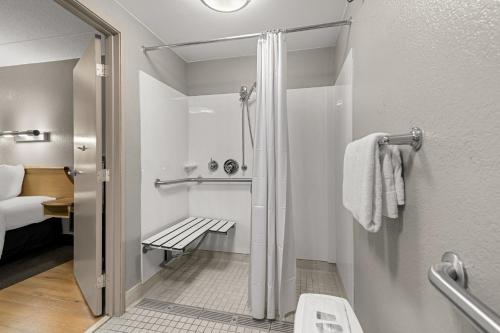a small bathroom with a shower and a toilet at Red Roof Inn Salem in Salem