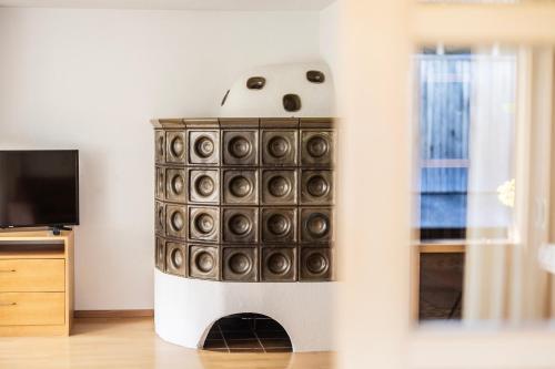a fireplace in a living room next to a tv at Schrannenhof in Schoppernau