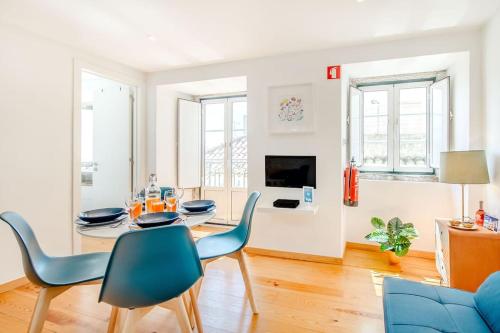 a living room with a dining room table and chairs at Alfama Charming Apartment in Lisbon