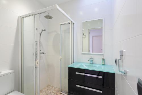 a bathroom with a glass shower and a sink at Ca na Carmen -Crestatx- in Crestatx