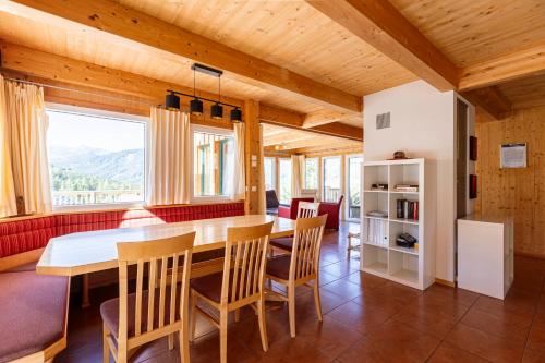 a kitchen and dining room with a table and chairs at Almdorf Hohentauern by ALPS RESORTS in Hohentauern