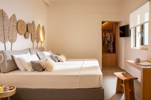 a bedroom with a bed with white sheets and pillows at Almyrida Resort in Almirida