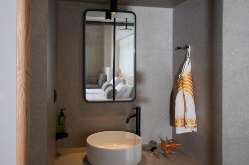 a bathroom with a sink and a mirror at Almyrida Resort in Almirida