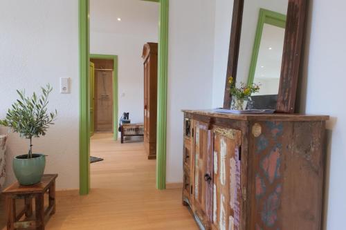 a mirror on top of a dresser in a hallway at Goldener Löwe in Bodman-Ludwigshafen
