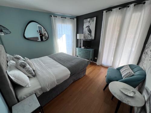 a bedroom with a bed and a mirror and a chair at Riviera Eden Palace in Cannes