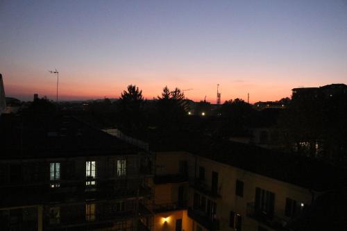 a sunset view of a city with buildings at Appartamento Alfieri in Asti