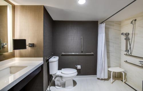 a bathroom with a toilet and a sink and a tub at Crowne Plaza Annapolis by IHG in Annapolis