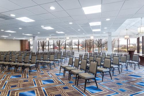 a room with rows of chairs in a building at Crowne Plaza Annapolis by IHG in Annapolis