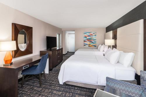 a hotel room with a large bed and a desk at Crowne Plaza Annapolis by IHG in Annapolis