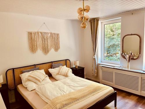 a bedroom with a bed with a mirror and a window at Heideglück an der Rotbuche in Soltau