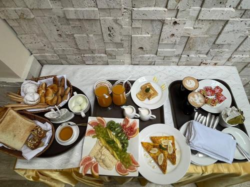 a table topped with plates of food and drinks at Villa Vista in Islamabad