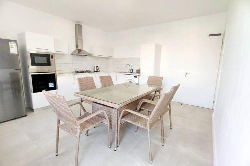 a kitchen with a table and chairs in a kitchen at Ocean Views & Stunning Sunsets 1st-Floor Villa in Flic-en-Flac