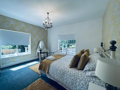 a bedroom with a bed and a chandelier at Stunning 3-Bed Cottage in Gateshead in Gateshead