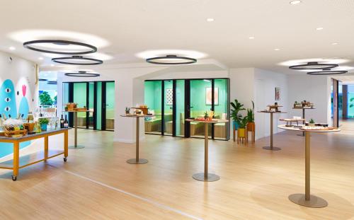 a large room with tables and glass windows at INNSiDE by Meliá Barcelona Apolo in Barcelona