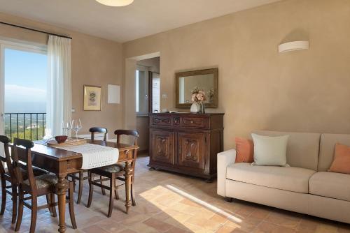 a living room with a table and a couch at I Ciabot di Monforte in Monforte dʼAlba