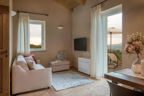 a living room with a couch and a television at I Ciabot di Monforte in Monforte dʼAlba