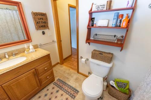 a bathroom with a toilet and a sink and a mirror at Mom & Pop's: Waterfront,Nature,Togetherness in Cambridge Springs