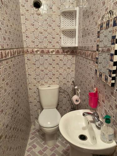 a bathroom with a toilet and a sink at appartement traditional cozy in Tangier