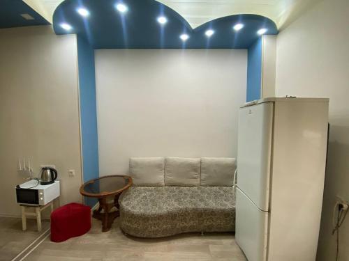 a room with a couch next to a refrigerator at Paronyan hostel in Yerevan