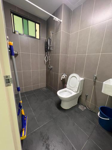 a bathroom with a toilet and a phone on the wall at Greenfield Residence - Sunway, Taylors, One Academy in Petaling Jaya