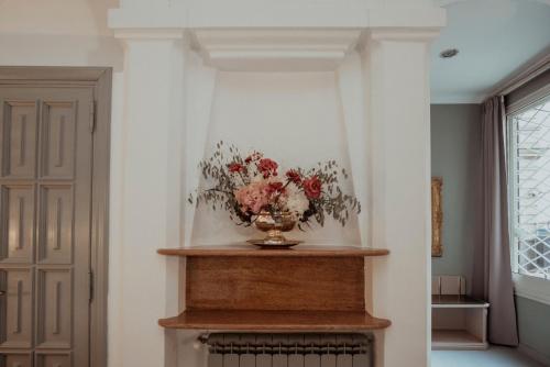 a vase of flowers sitting on top of a fireplace at Hotel Marisa in Rome