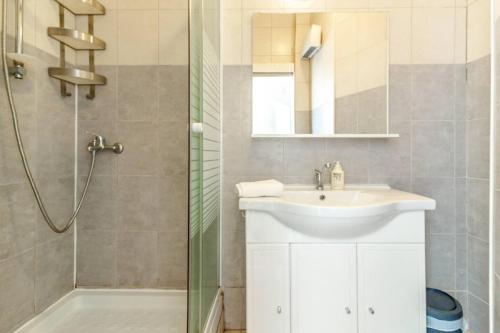 uma casa de banho com um lavatório e um chuveiro em Canebière 3 // Bel appartement climatisé avec terrasse em Marselha
