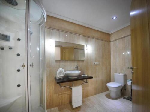 a bathroom with a sink and a toilet and a shower at 0322 Apartment in Carballo in Carballo