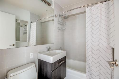 a bathroom with a sink and a toilet and a shower at Chelsea 1br w doorman gym nr Union Square NYC-1240 in New York