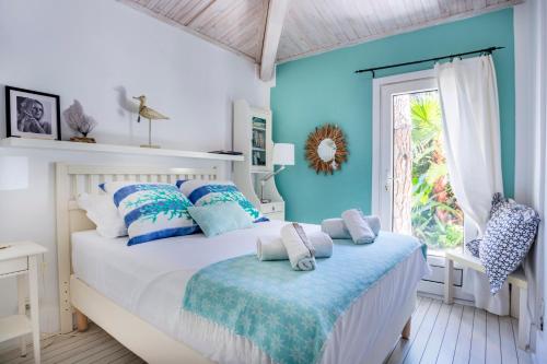 a bedroom with a bed with blue walls and a window at Casa Bambou An hidden gem near Saint Tropez with private pool in Gassin