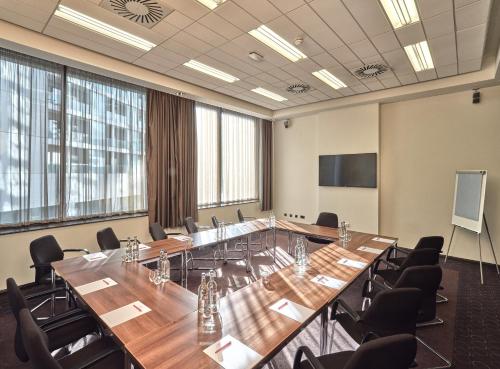 a conference room with a large table and chairs at Crowne Plaza Birmingham City by IHG in Birmingham