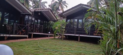 a building with a hose attached to the grass at Seascape by Sand Sapphire in Canacona
