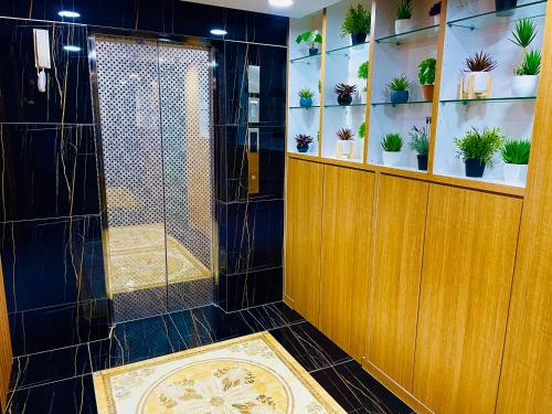 a bathroom with a shower with potted plants at Cozy Hotel@ KL Sentral in Kuala Lumpur