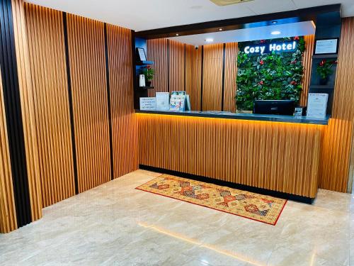 a restaurant with a cash register and a counter at Cozy Hotel@ KL Sentral in Kuala Lumpur