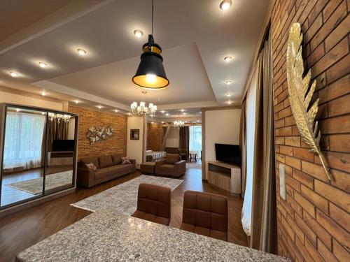 a living room with a brick wall at CITY STAY Апарт-Отель Алматы in Almaty