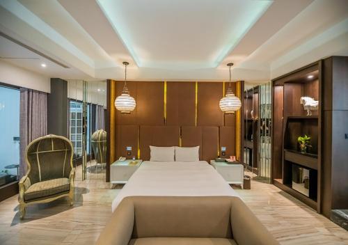 a bedroom with a large bed and a couch at Feng Cai Motel in Yuanlin