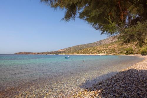 a view of a beach with a boat in the water at Chariclea Villas Retreat in Samos