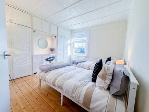 a bedroom with two beds and a window at Cosy Windsor Cottage - Free Parking included in Windsor