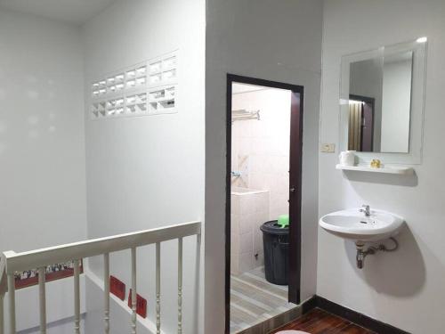 a white bathroom with a sink and a mirror at 7/7 House, Classic House for family in Hat Yai