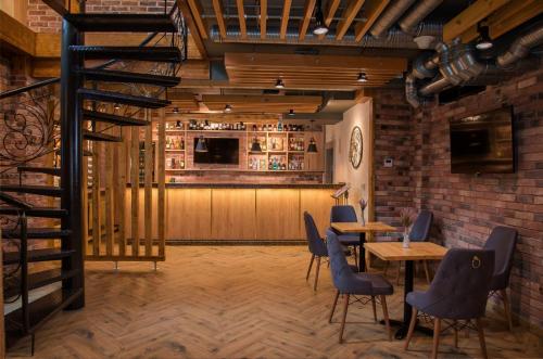 a restaurant with tables and chairs and a bar at CITY STAY Апарт-Отель Алматы in Almaty